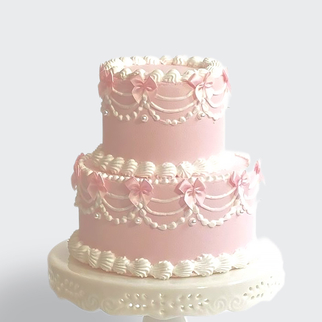 Торт 2 яруса розовый с бантиками в стиле ламбет